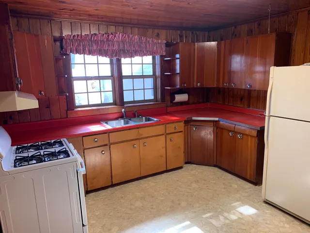a kitchen with stainless steel appliances a refrigerator sink and cabinets