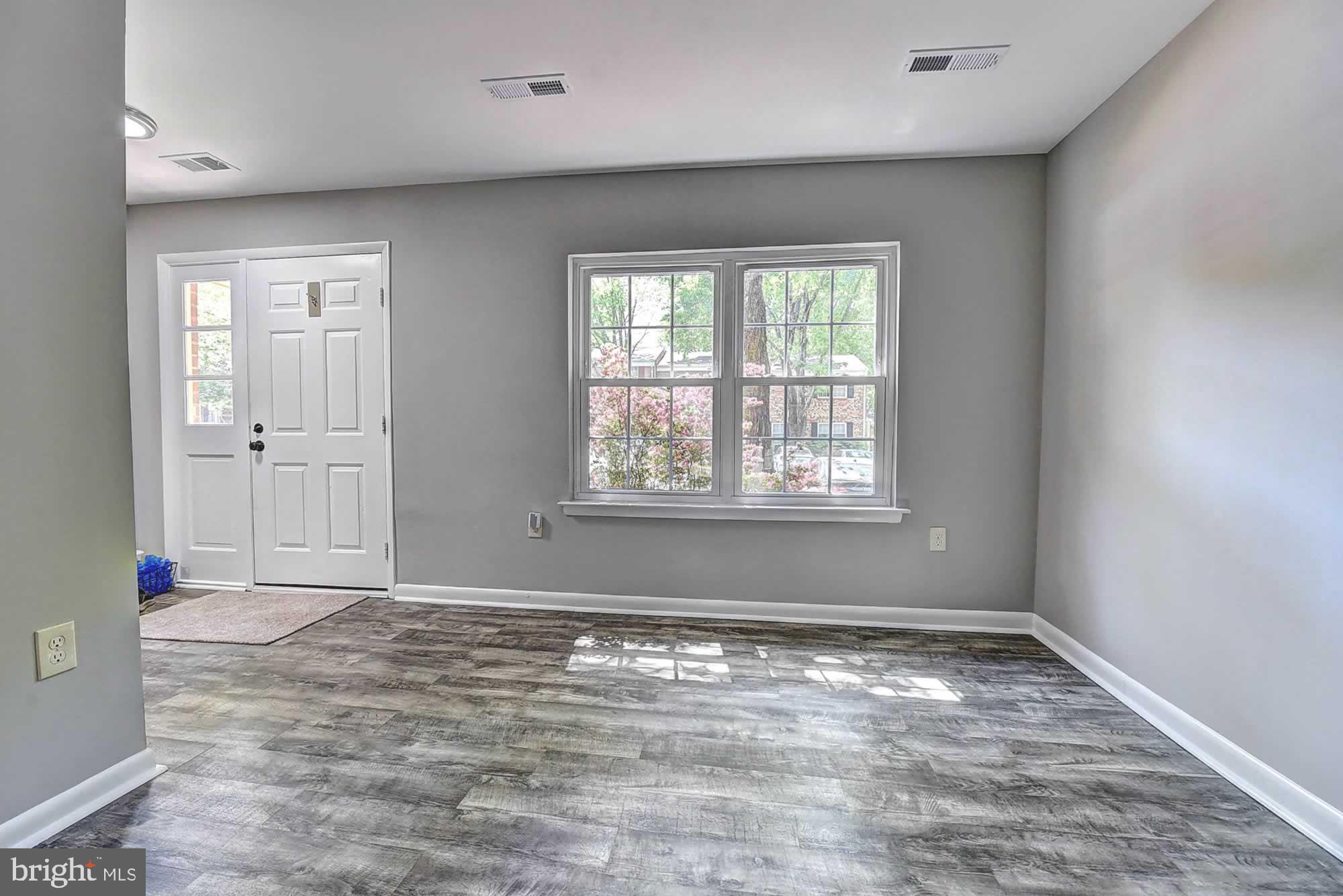 2226 Gunsmith Square Reston, VA 20191 - Photo 9 of 35 an empty room with wooden floor and windows