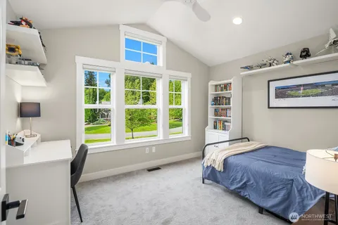 a spacious bedroom with a bed and a window
