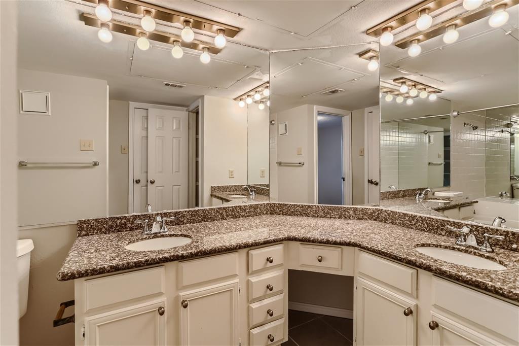 16301 Ledgemont Lane, Unit 269 Addison, TX 75001 - Photo 15 of 22 a bathroom with a granite countertop sink and a mirror