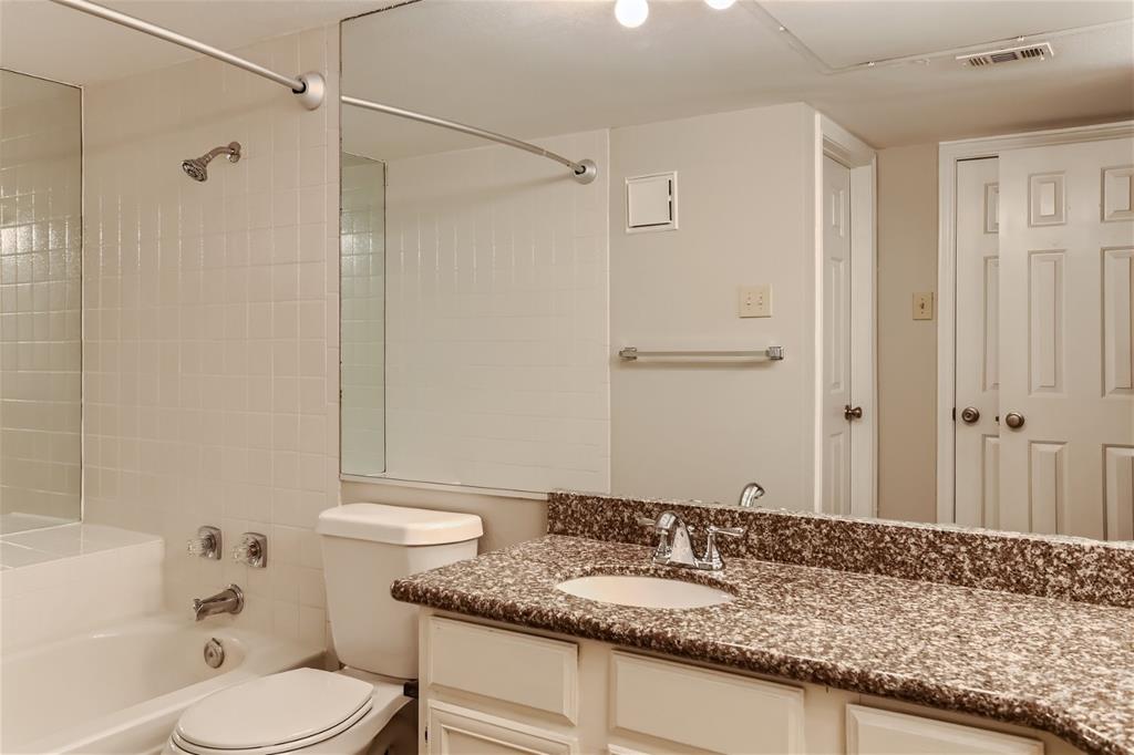 16301 Ledgemont Lane, Unit 269 Addison, TX 75001 - Photo 16 of 22 a bathroom with a granite countertop sink and a mirror