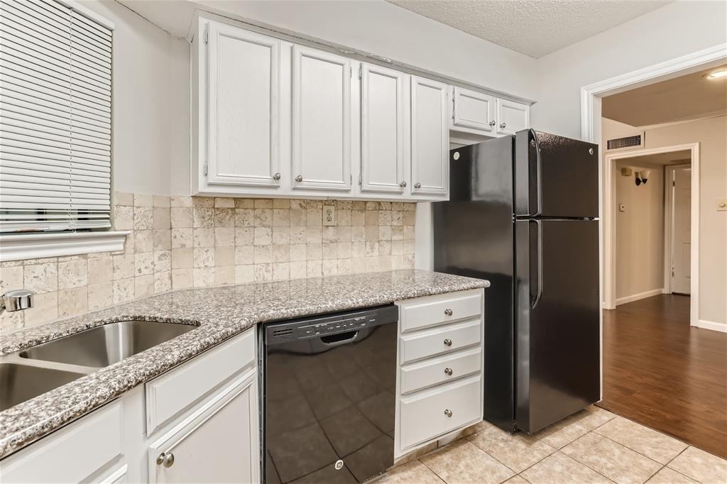 16301 Ledgemont Lane, Unit 269 Addison, TX 75001 - Photo 3 of 22 a kitchen with granite countertop a refrigerator and a sink