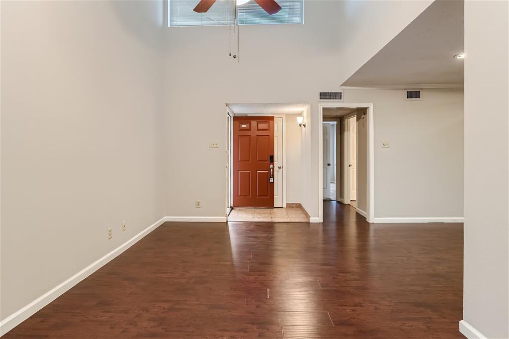 16301 Ledgemont Lane, Unit 269 Addison, TX 75001 - Photo 6 of 22 a view of an empty room with wooden floor