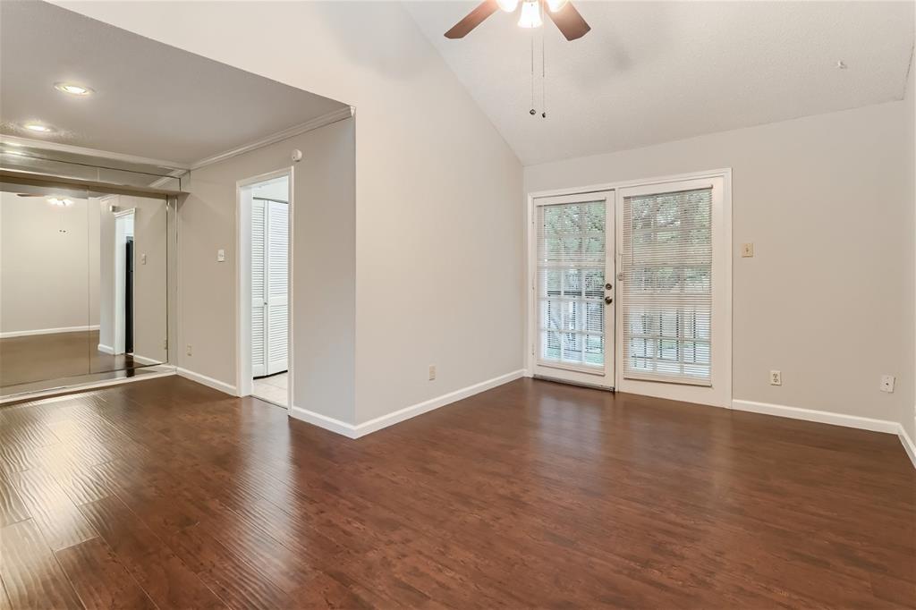 16301 Ledgemont Lane, Unit 269 Addison, TX 75001 - Photo 8 of 22 a view of an empty room with wooden floor and a window