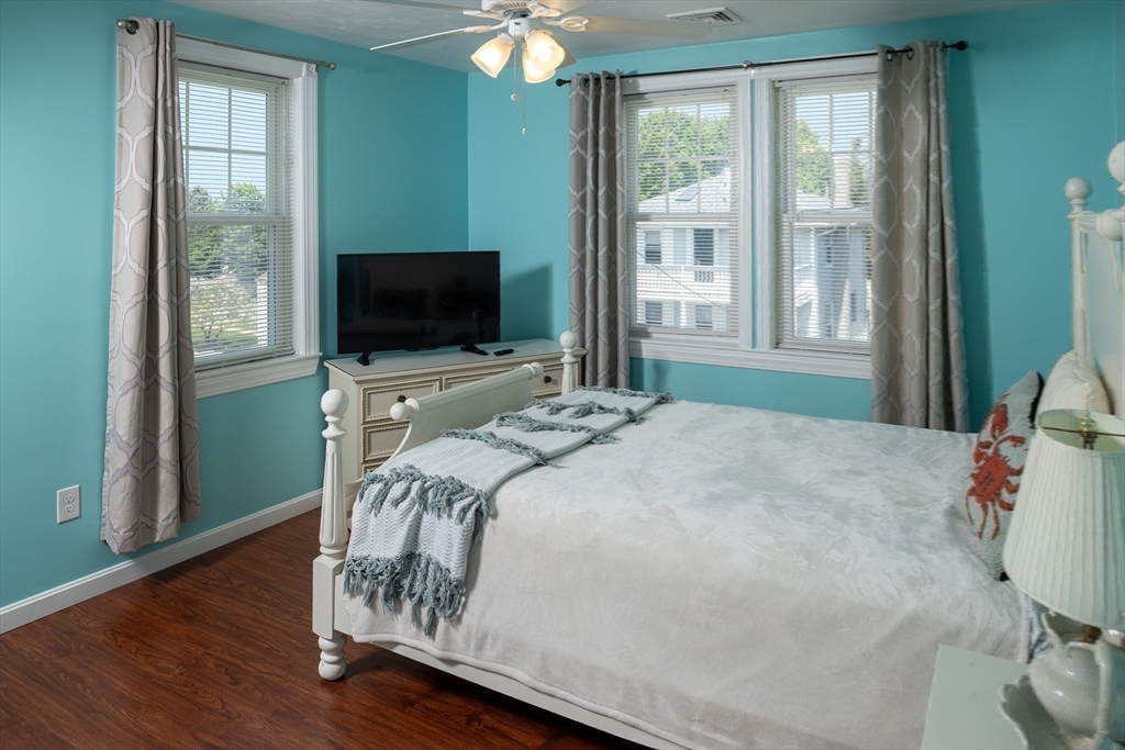 67 Newport Road Hull, MA 02045 - Photo 21 of 26 a bedroom with a bed and flat screen tv