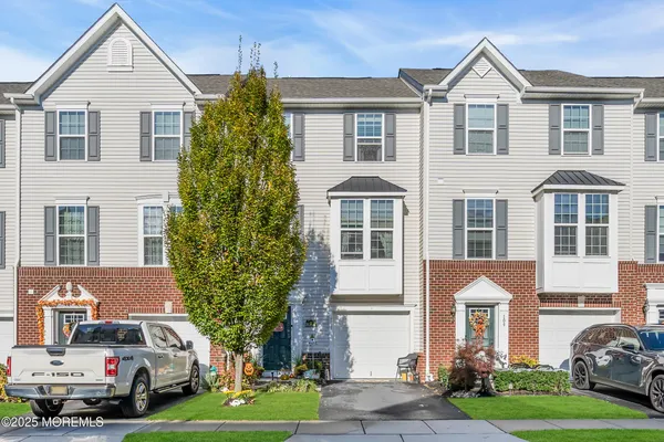 a front view of a residential apartment building with a yard