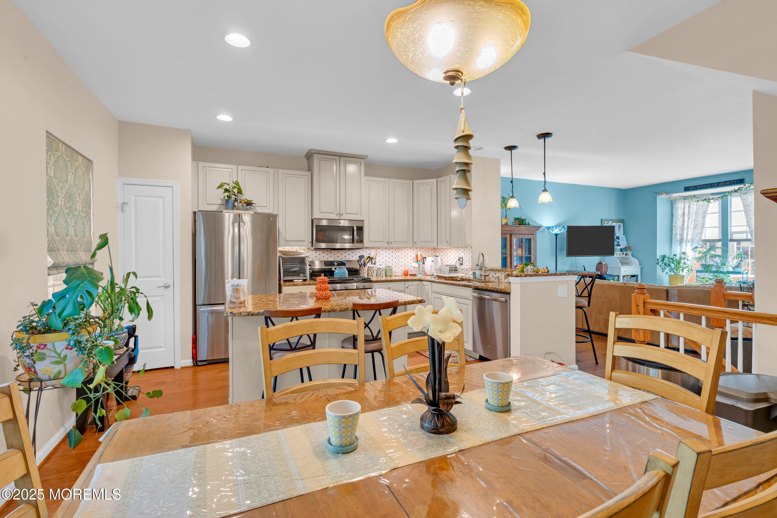 111 Spirit Way Brick, NJ 08723 - Photo 13 of 39 a kitchen with stainless steel appliances kitchen island granite countertop a refrigerator a stove a sink dishwasher and white cabinets with wooden floor