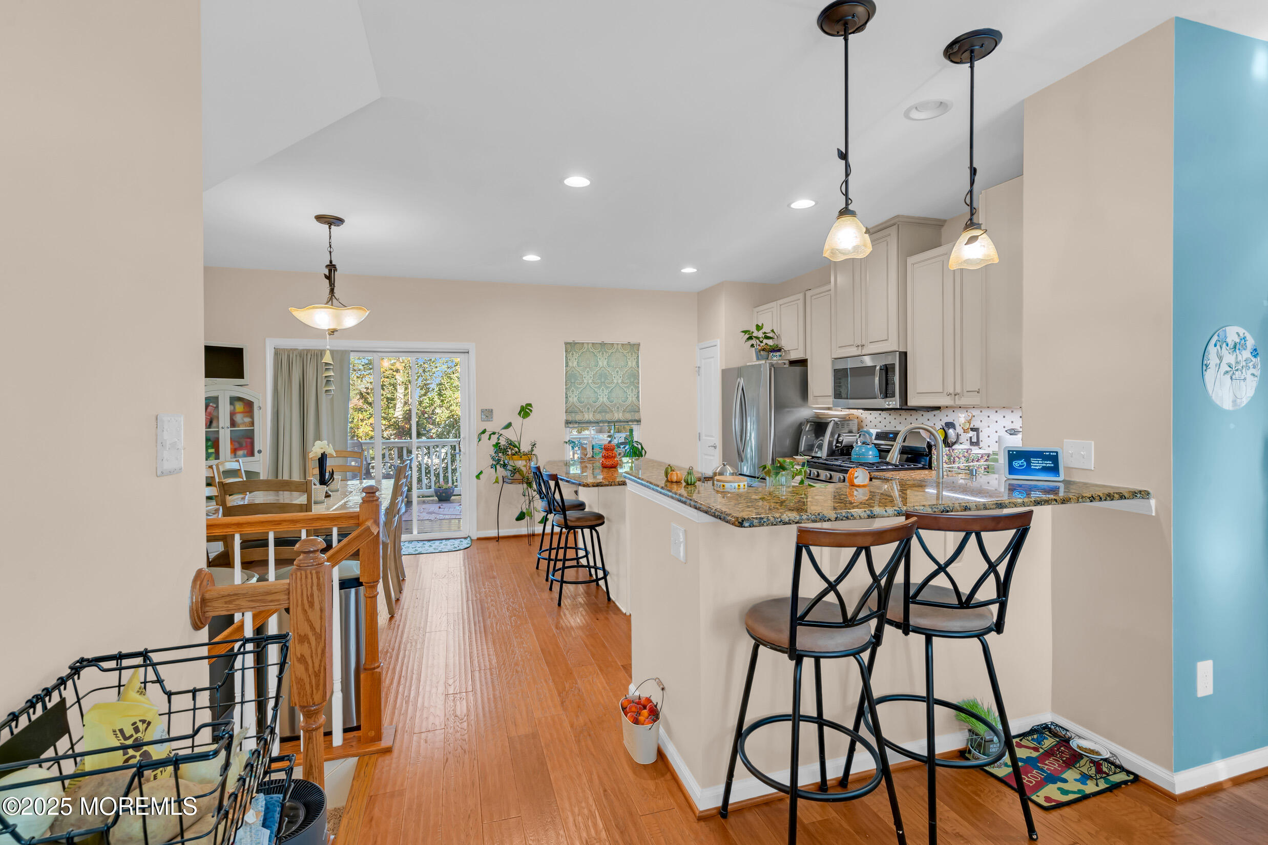 111 Spirit Way Brick, NJ 08723 - Photo 14 of 39 a view of a dining room and livingroom with furniture wooden floor a chandelier