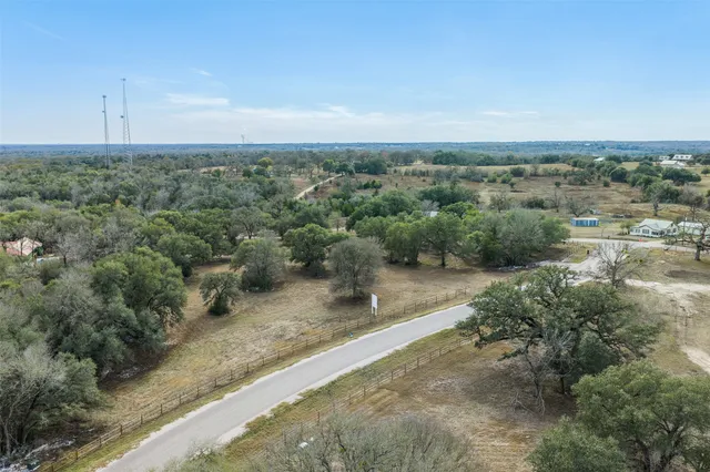 an aerial view of a houses with outdoor space and trees