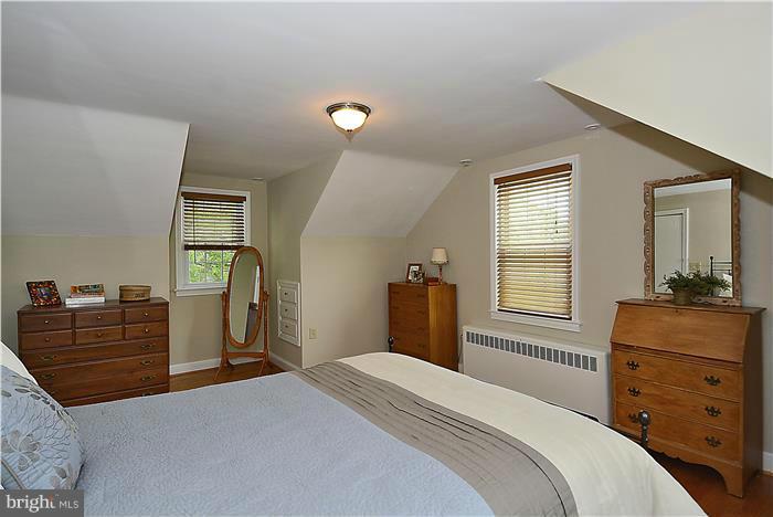 1900 Rookwood Road Silver Spring, MD 20910 - Photo 14 of 30 a bedroom with a bed and wooden floor
