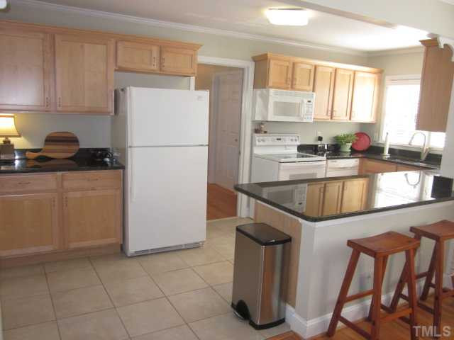 2031 Reaves Drive Raleigh, NC 27608 - Photo 17 of 25 Completely updated kitchen! This is a major expense already done for the buyer! Ceramic tile floors and great eat at bar! Refrigerator STAYS! Kitchen