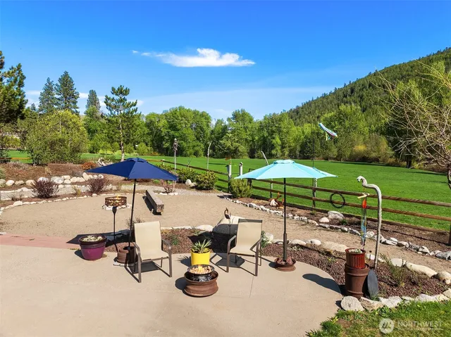 a view of a table and chairs under an umbrella