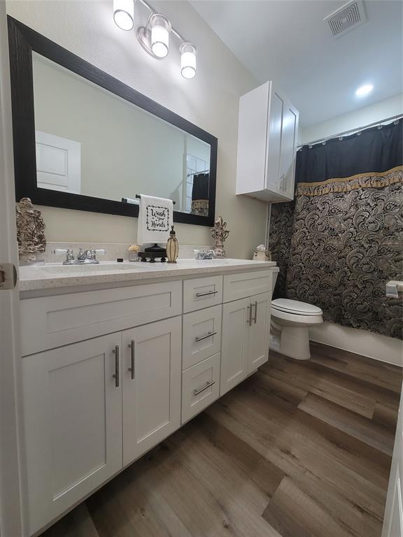 4825 Wichita Street Granbury, TX 76048 - Photo 25 of 30 a bathroom with a double vanity sink and a mirror