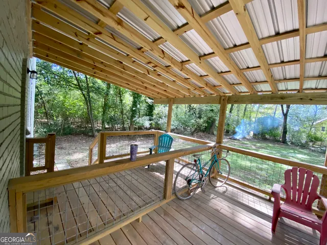 a view of a balcony with furniture and wooden floor