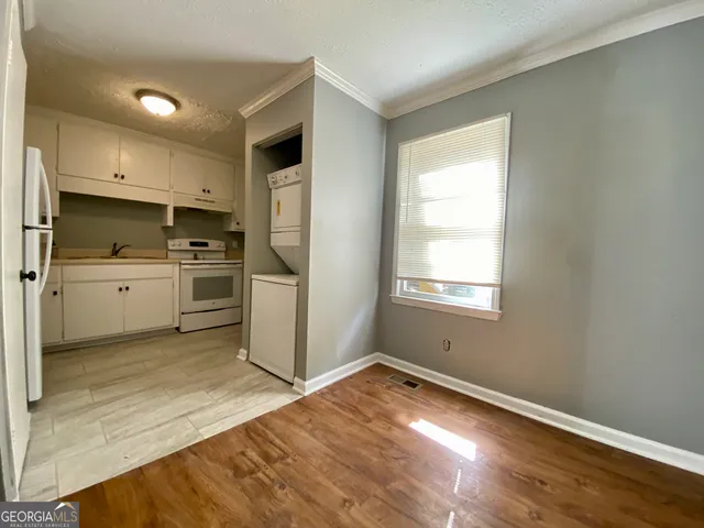 a kitchen with a refrigerator and a stove top oven