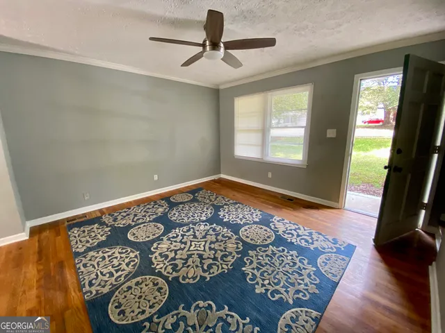 a picture of a room with window and hardwood floor