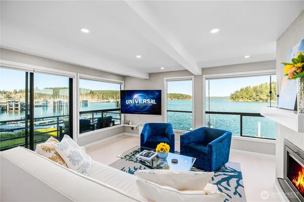 a living room with fireplace furniture and a large window