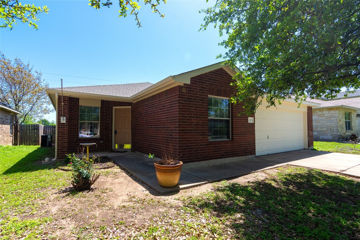 245 Shale Drive Jarrell, TX 76537 - Photo 1 of 1 a front view of a house with garden