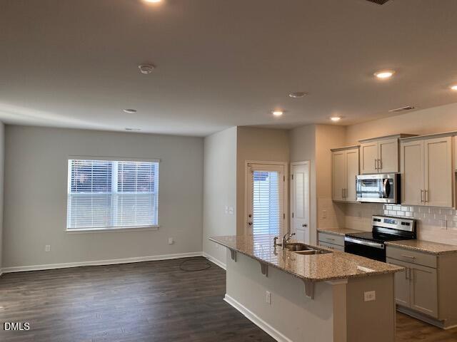 1278 Adrian Court Mebane, NC 27302 - Photo 15 of 33 a kitchen with kitchen island granite countertop a sink cabinets and wooden floor