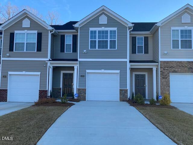 1278 Adrian Court Mebane, NC 27302 - Photo 2 of 33 a front view of a house with a yard and garage