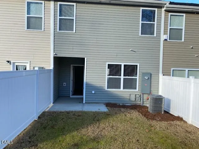 a front view of a house with wooden fence