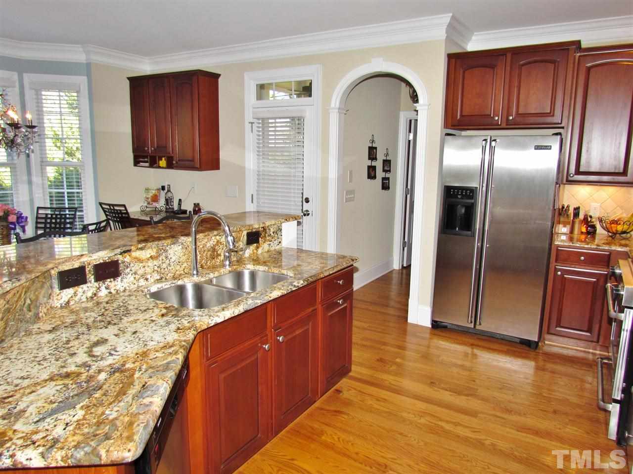 3810 Congeniality Way Raleigh, NC 27613 - Photo 11 of 25 View looking to the spacious and sunny eat-in area. Note the lovely granite. A built-desk is to the right next to the entrance to the screened in porch!