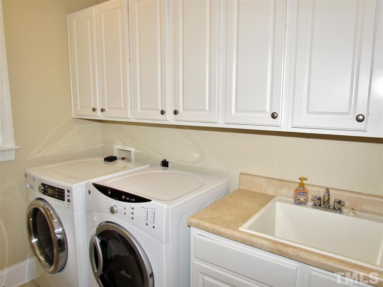 3810 Congeniality Way Raleigh, NC 27613 - Photo 15 of 25 If you've got to do laundry might as well be here. Plenty of room- many storage cabinets, a counter to fold, big laundry sink and a window to let in the light!