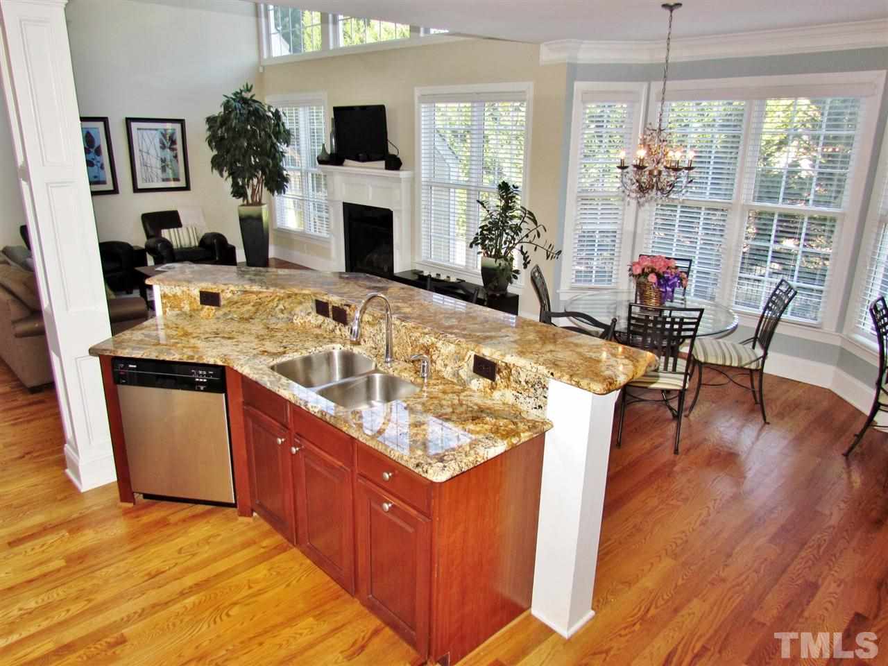 3810 Congeniality Way Raleigh, NC 27613 - Photo 9 of 25 Gorgeous kitchen is open and inviting. Level of granite counter-top is usually found in higher price points. Who wouldn't want to prepare a sumptuous feast here! Note abundance of outlets, gooseneck faucet and double sink.