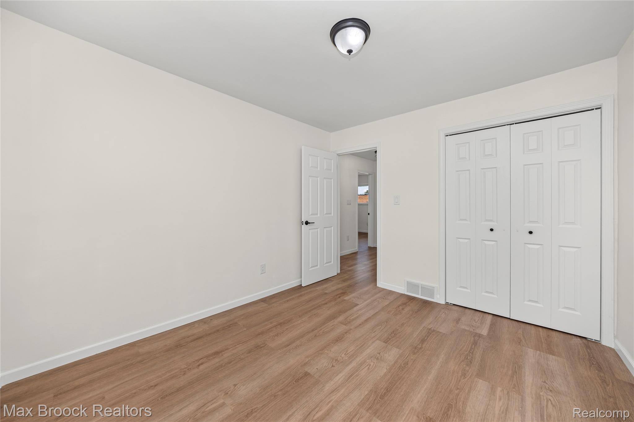 1544 Sheffield Road Birmingham, MI 48009 - Photo 21 of 51 Unfurnished bedroom with light wood-style flooring and a closet