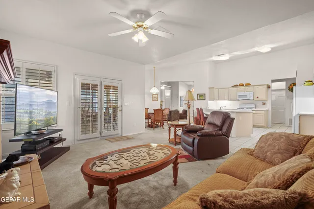 a living room with furniture a fireplace and a table