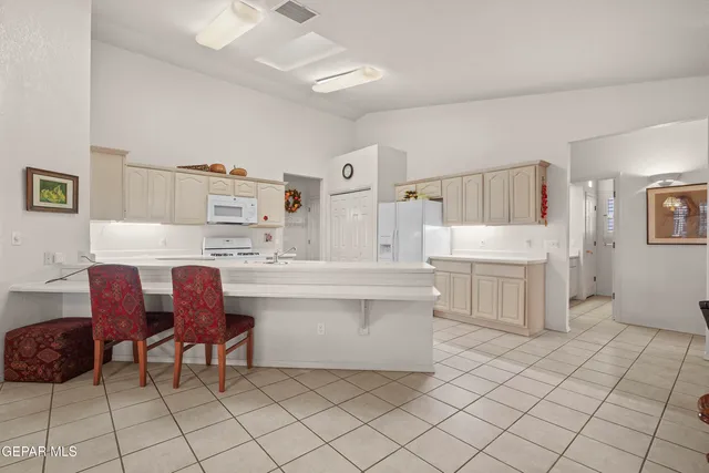 a kitchen with white cabinets and white appliances