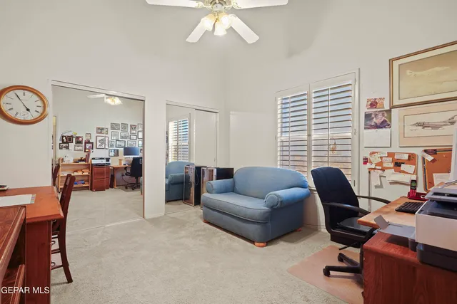 a view of a livingroom with workspace and a couch