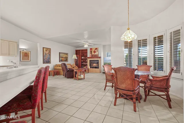 a dining room with furniture a chandelier and window