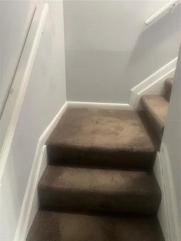 a bathroom with a granite countertop toilet and a sink