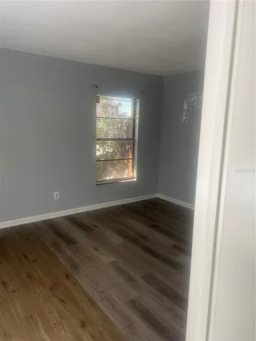 a kitchen with a sink a refrigerator and cabinets