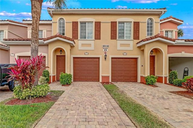 a front view of a house with a yard and a garage