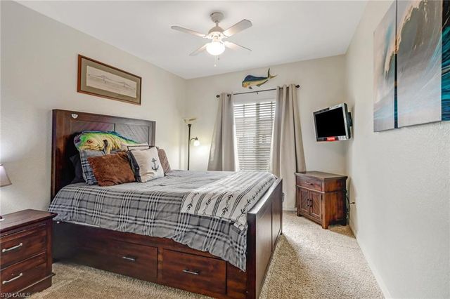 a bedroom with a bed and a television