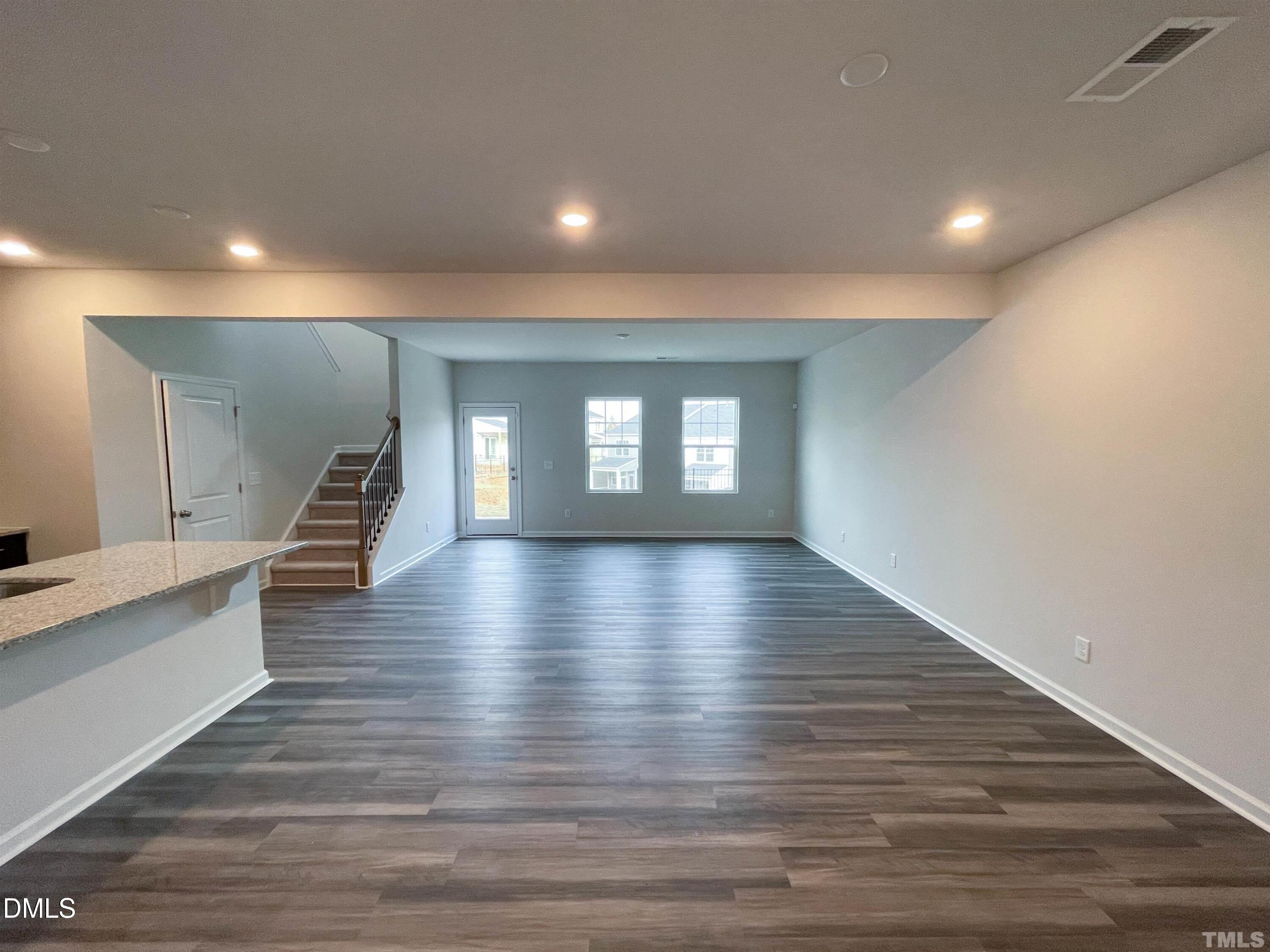 6525 Mezzo Lane Raleigh, NC 27616 - Photo 16 of 38 a view of an empty room with wooden floor and a window
