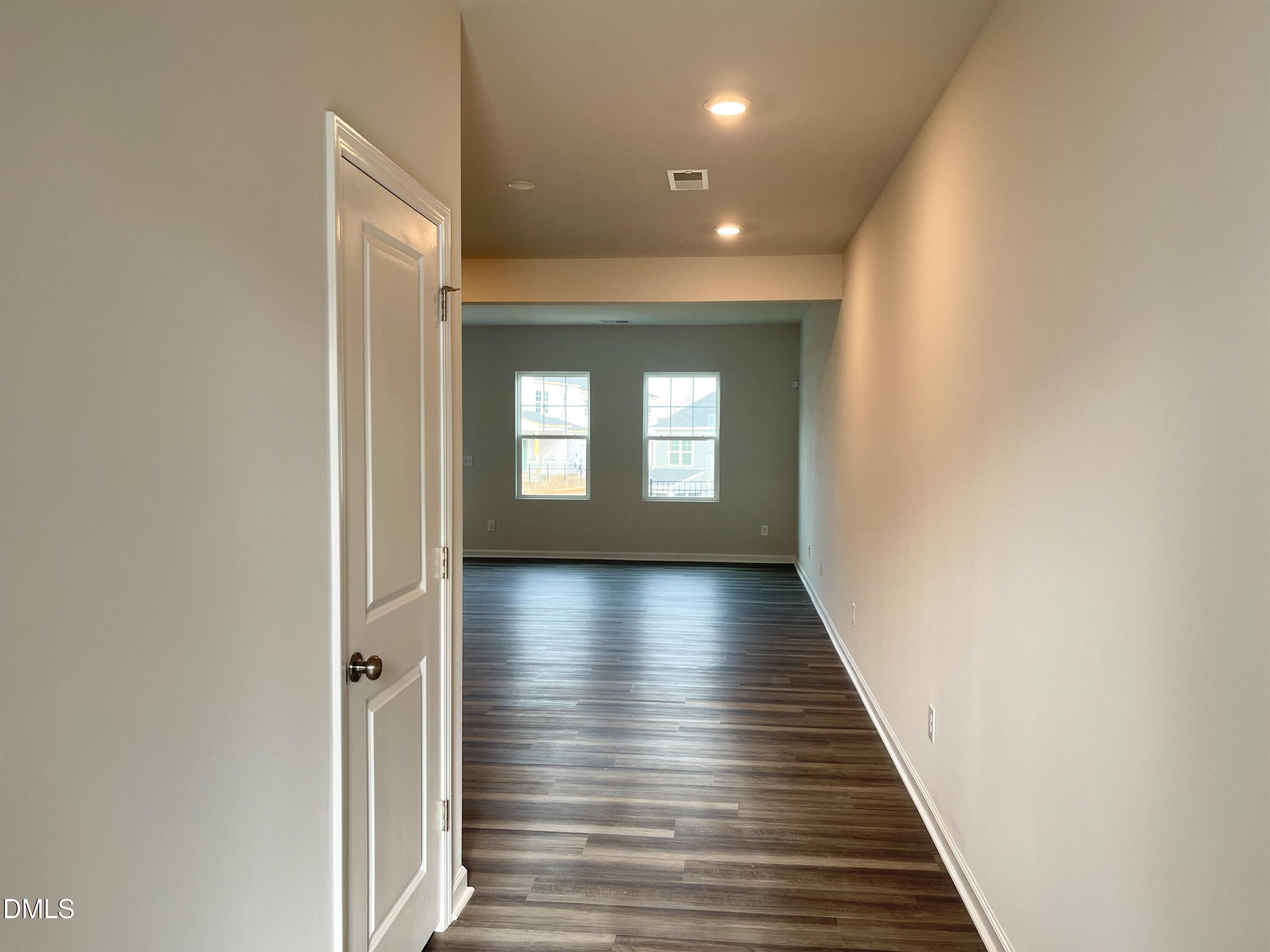 6525 Mezzo Lane Raleigh, NC 27616 - Photo 4 of 38 a view of a hallway with wooden floor and staircase