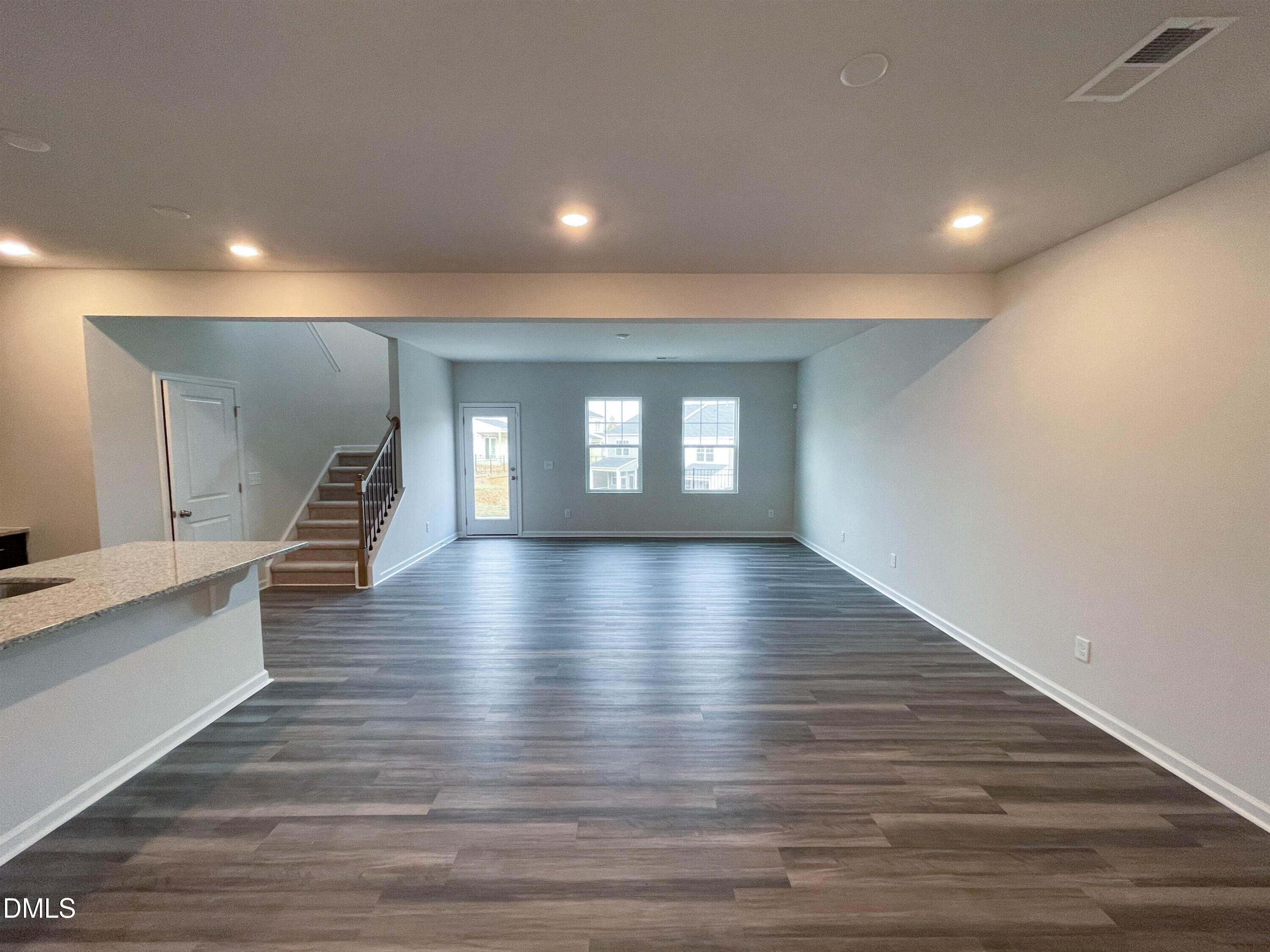 6525 Mezzo Lane Raleigh, NC 27616 - Photo 5 of 38 a view of an empty room with wooden floor and a window