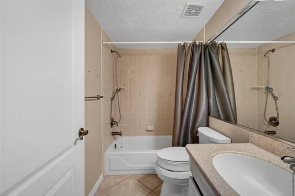 a spacious bathroom with a granite countertop sink and a mirror