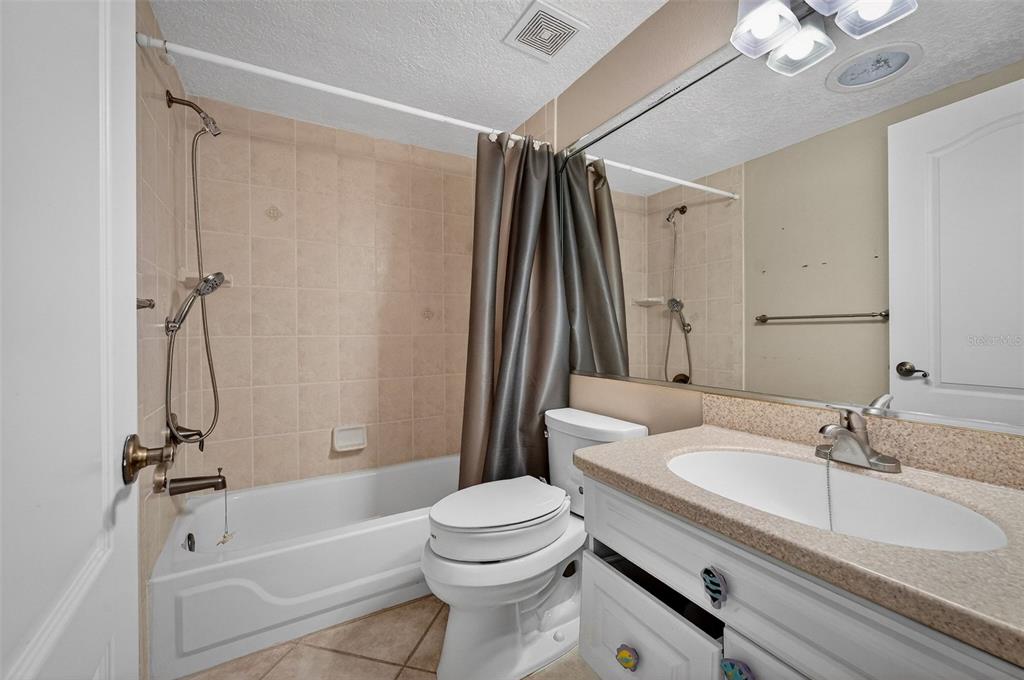 4875 Sailfish Drive Ponce Inlet, FL 32127 - Photo 22 of 60 a bathroom with a sink a toilet and a bathtub