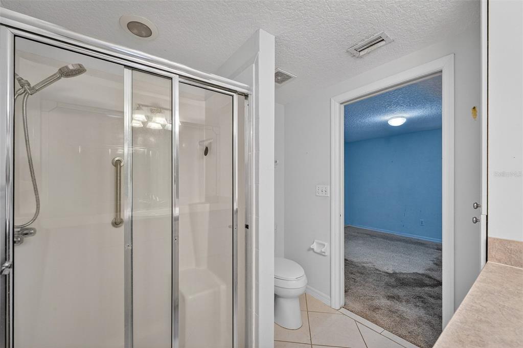4875 Sailfish Drive Ponce Inlet, FL 32127 - Photo 27 of 60 a bathroom that has a glass shower door
