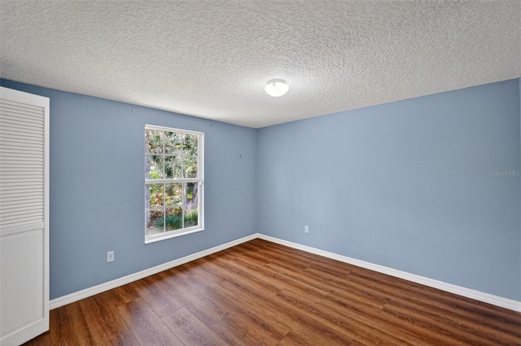 4875 Sailfish Drive Ponce Inlet, FL 32127 - Photo 30 of 60 an empty room with wooden floor and windows