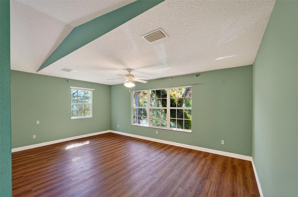 4875 Sailfish Drive Ponce Inlet, FL 32127 - Photo 36 of 60 a view of an empty room with wooden floor and a window