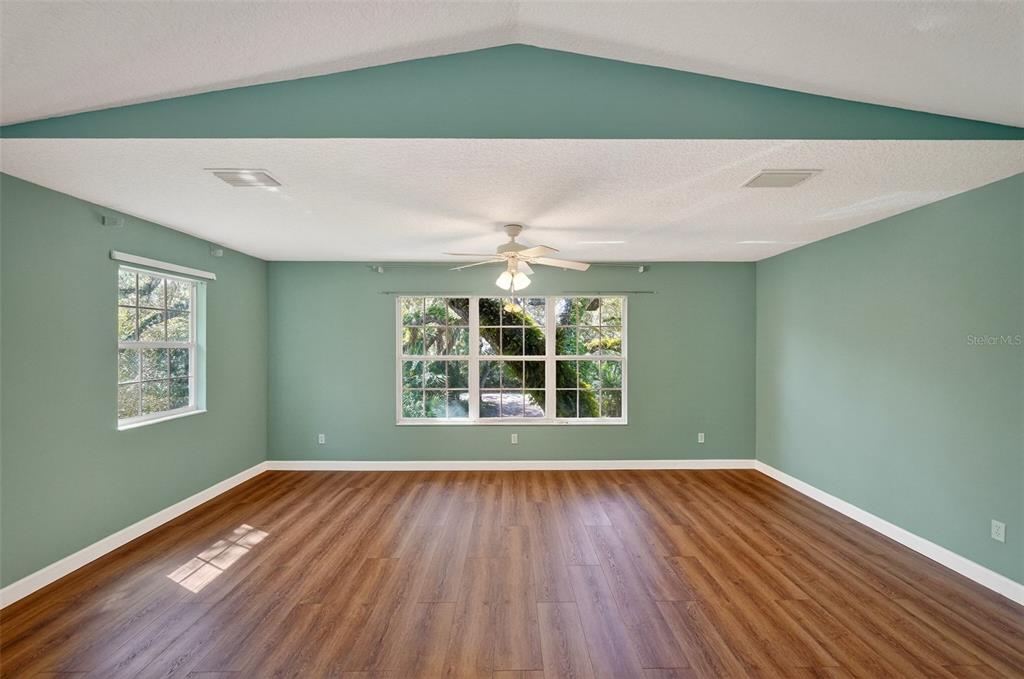 4875 Sailfish Drive Ponce Inlet, FL 32127 - Photo 40 of 60 a view of an empty room with wooden floor and a window