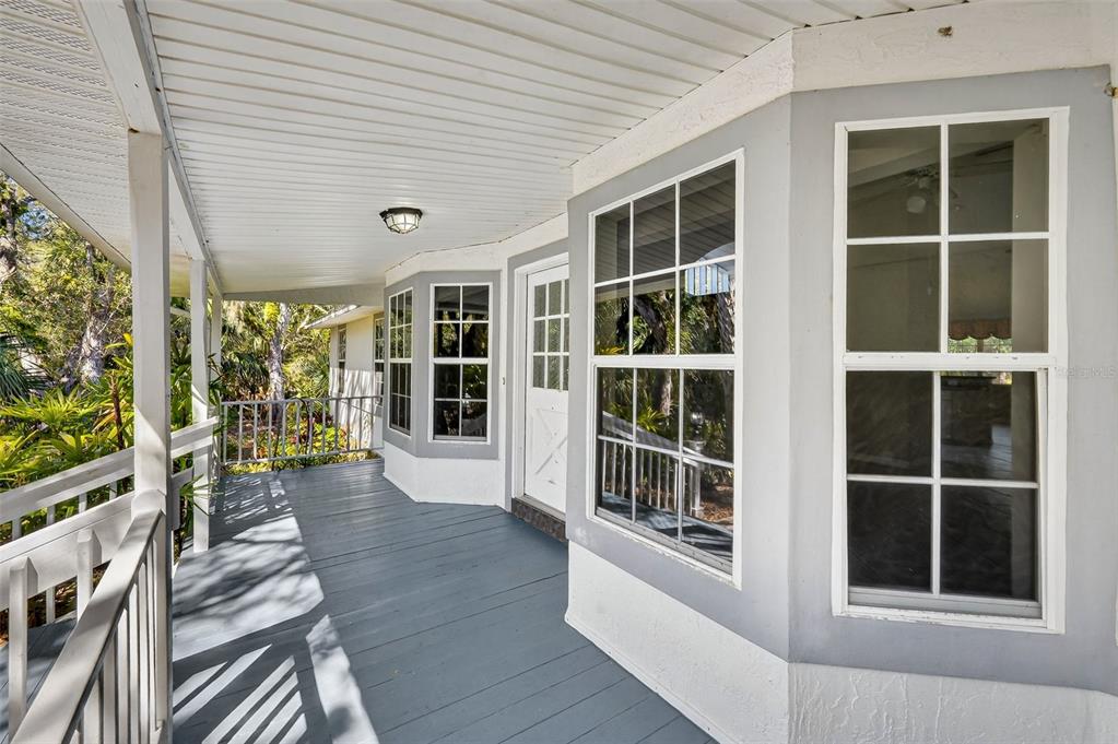 4875 Sailfish Drive Ponce Inlet, FL 32127 - Photo 4 of 60 a view of an entryway with wooden floor and windows