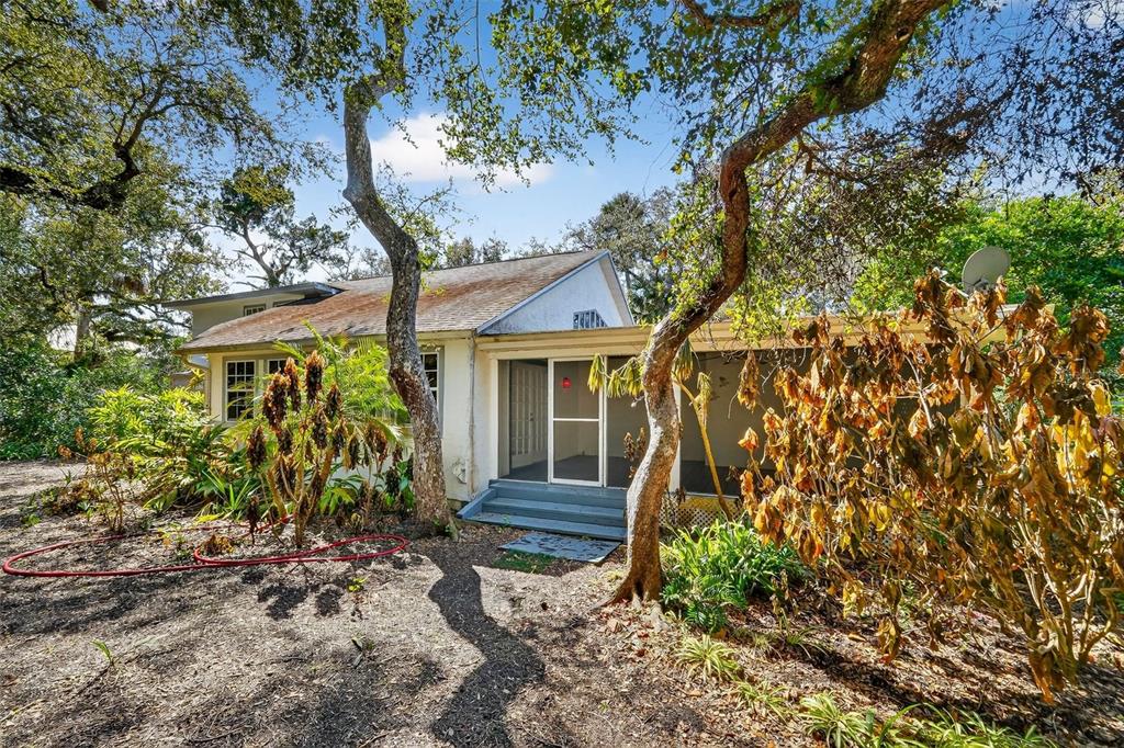 4875 Sailfish Drive Ponce Inlet, FL 32127 - Photo 48 of 60 a front view of a house with garden