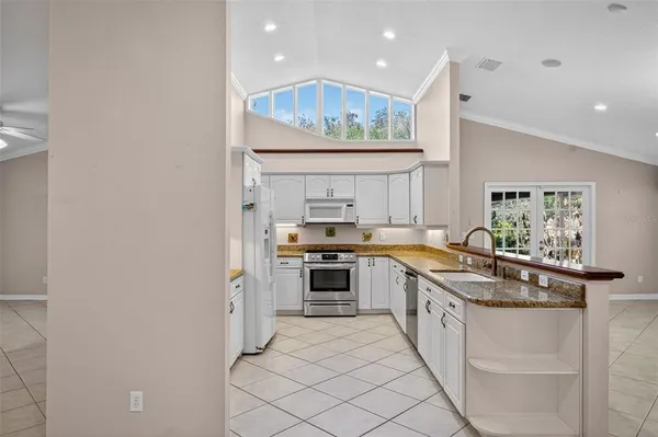 a kitchen with a sink cabinets and window