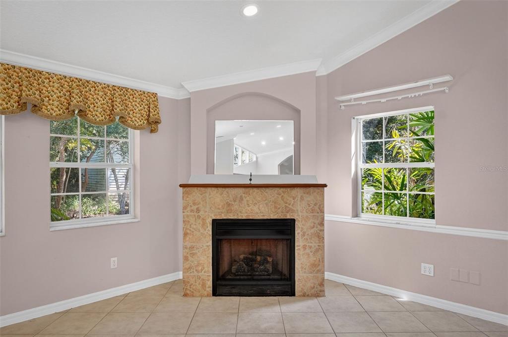 4875 Sailfish Drive Ponce Inlet, FL 32127 - Photo 8 of 60 a living room with a fireplace and a window